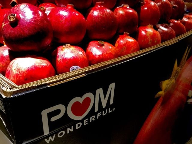 Grocery display of pomegranates