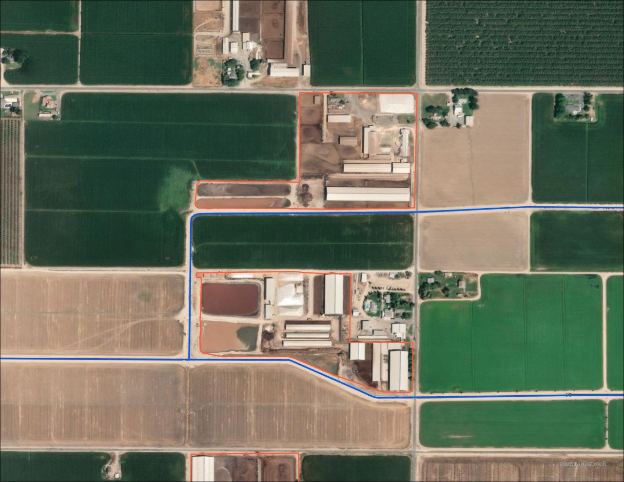 Zoomed out view of above image, with CAFOs outlined in orange and irrigation canals indicated in blue.