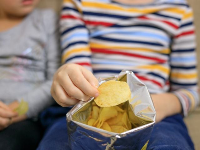 Children eating potato chips